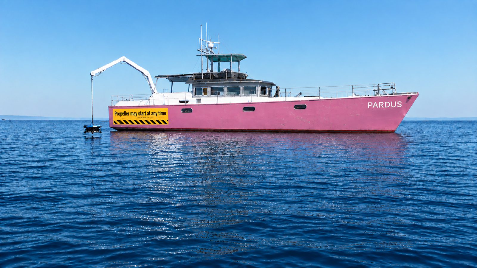 Survey vessel Pardus at sea with a sensor package suspended from its crane